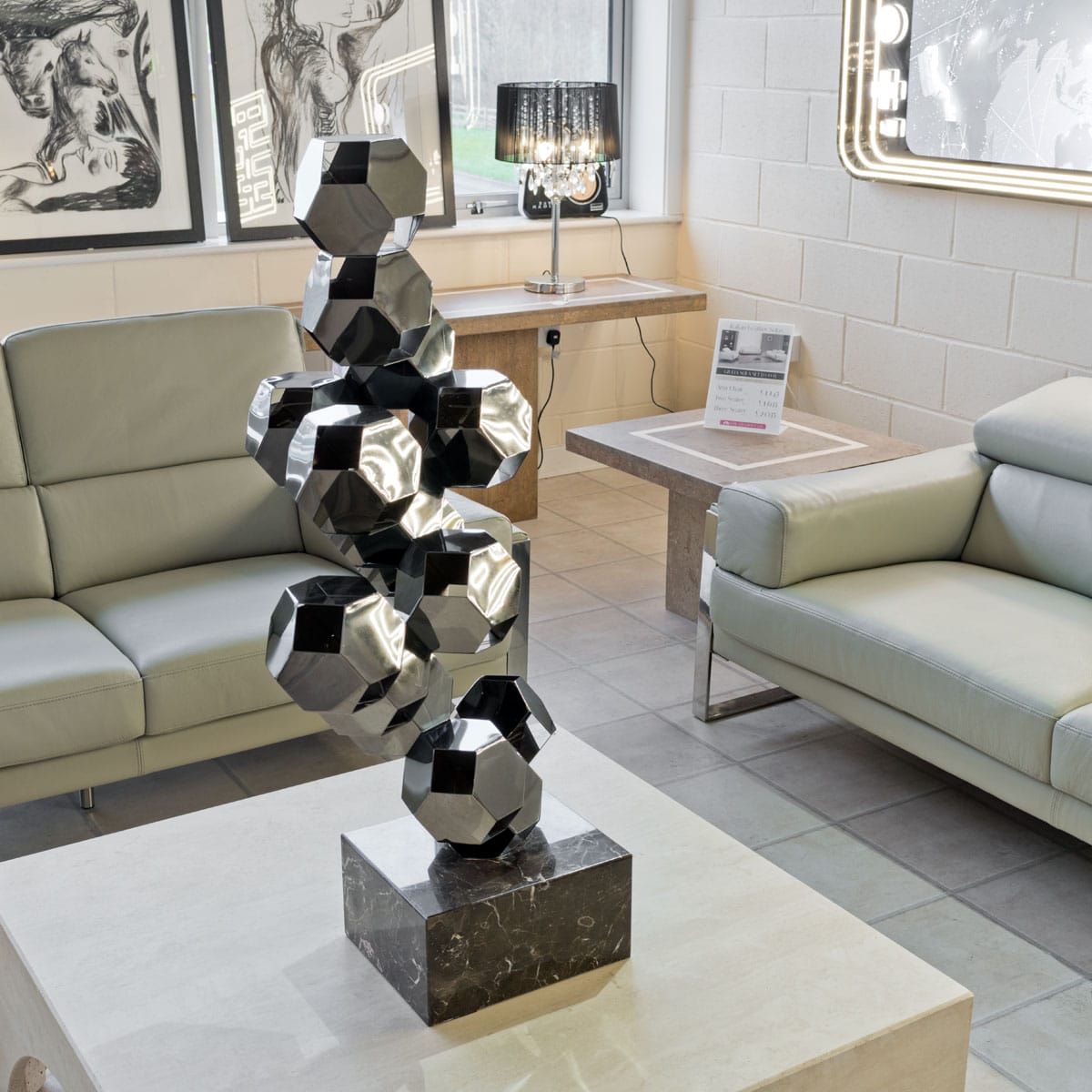 Rhombic Dodecahedron Tower Sculpture on display in our Showroom on a coffee table