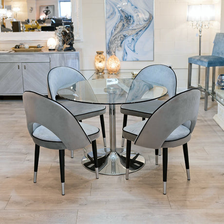 Cassidy grey dining chairs around a clear glass dining table